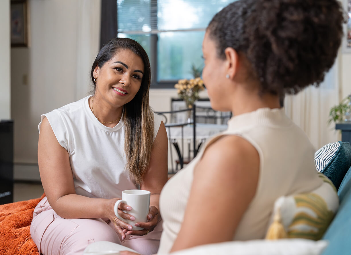 Three happy women drinking coffee