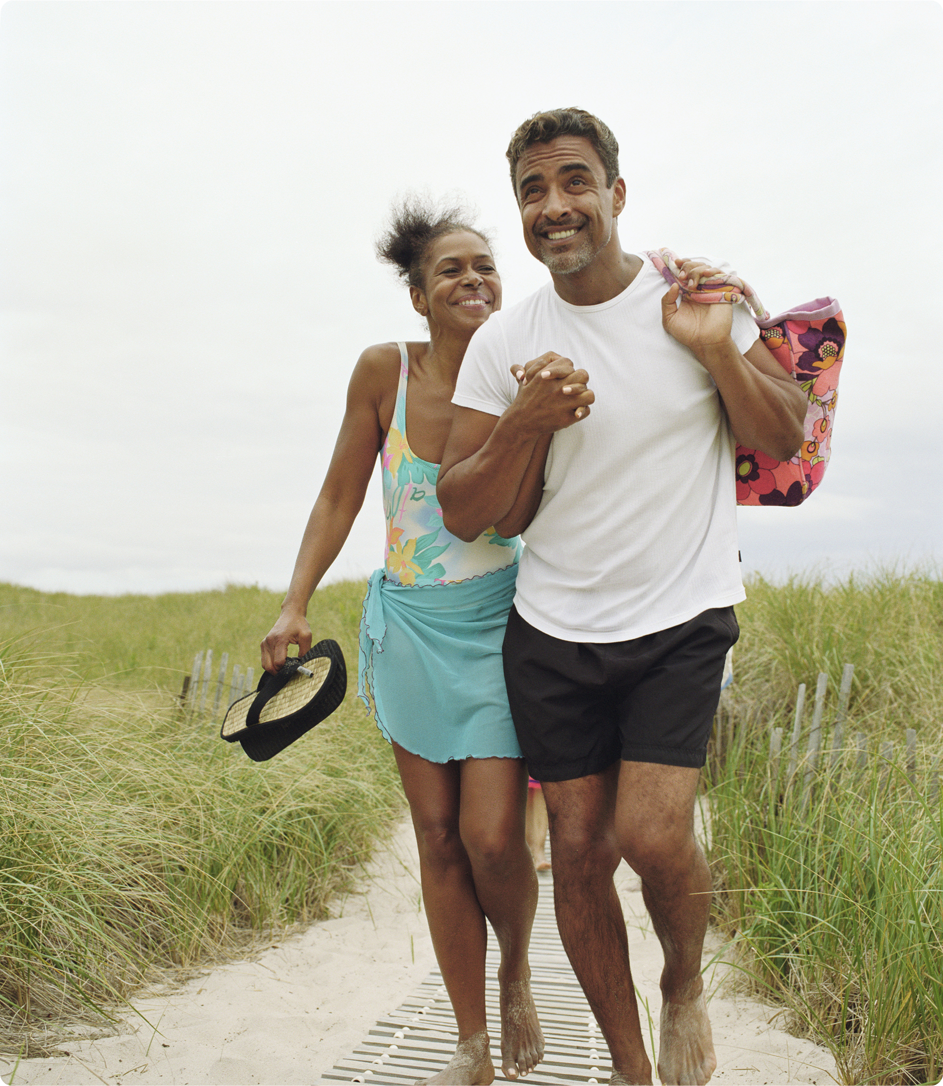 A woman and man walking on the beach