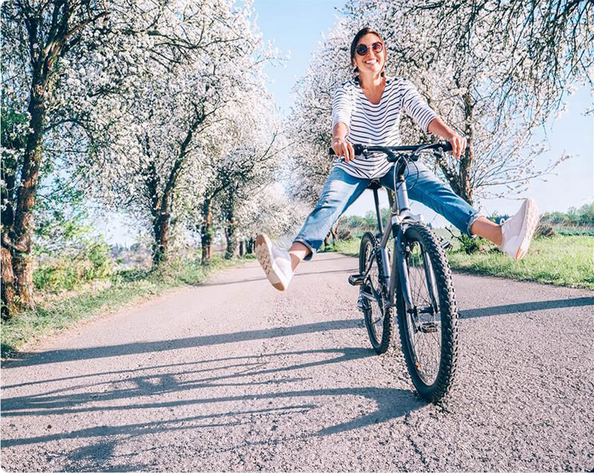 A woman riding a bike in comfort because she had a HAE procedure