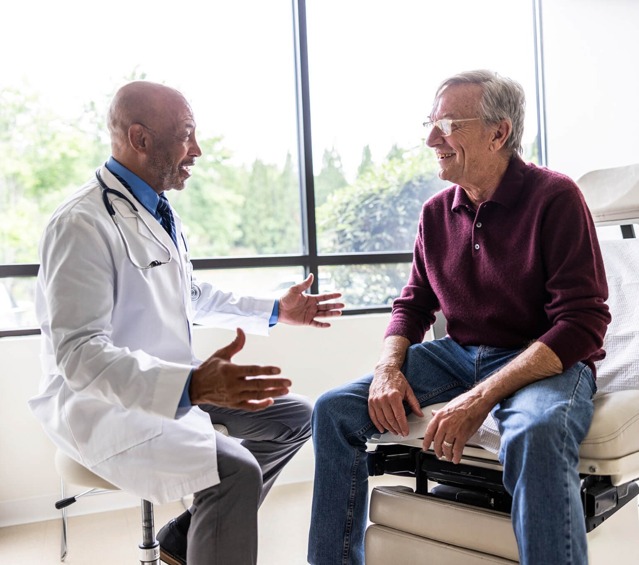 A man discussing the kyphoplasty and vertebroplasty procedure with his doctor.